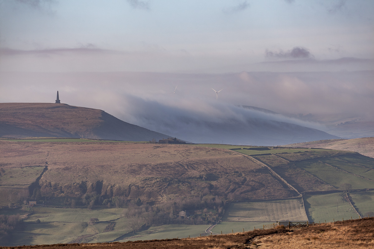 Fog rising behind Stoodley Pike monument